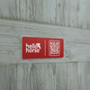 Red Hello Horse plate on grey wood